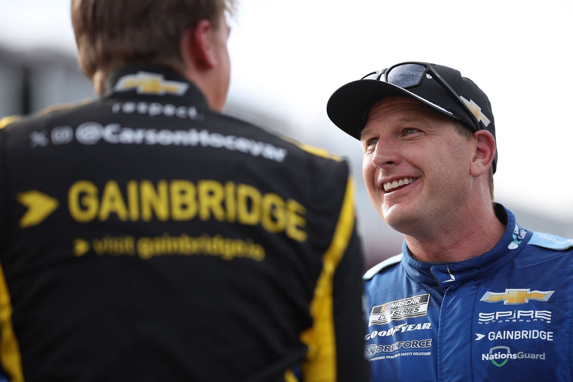 Spire Motorsports' Michael McDowell speaks to Carson Hocevar after the 2025 NASCAR Cup Series All-Star Open. Source: Getty